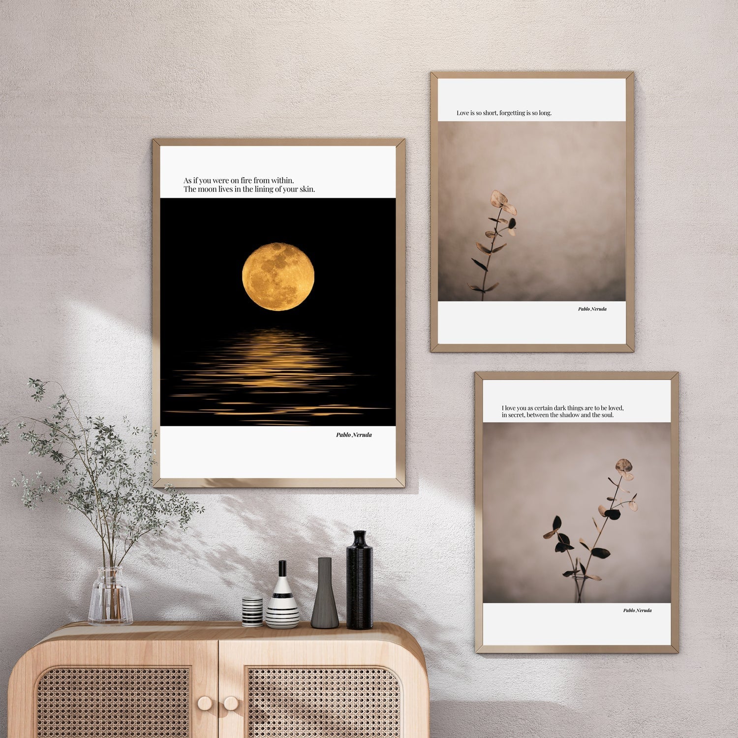 Three minimalist quote posters in wooden frames displayed on a wall above a wooden sideboard with plants and decorative vases