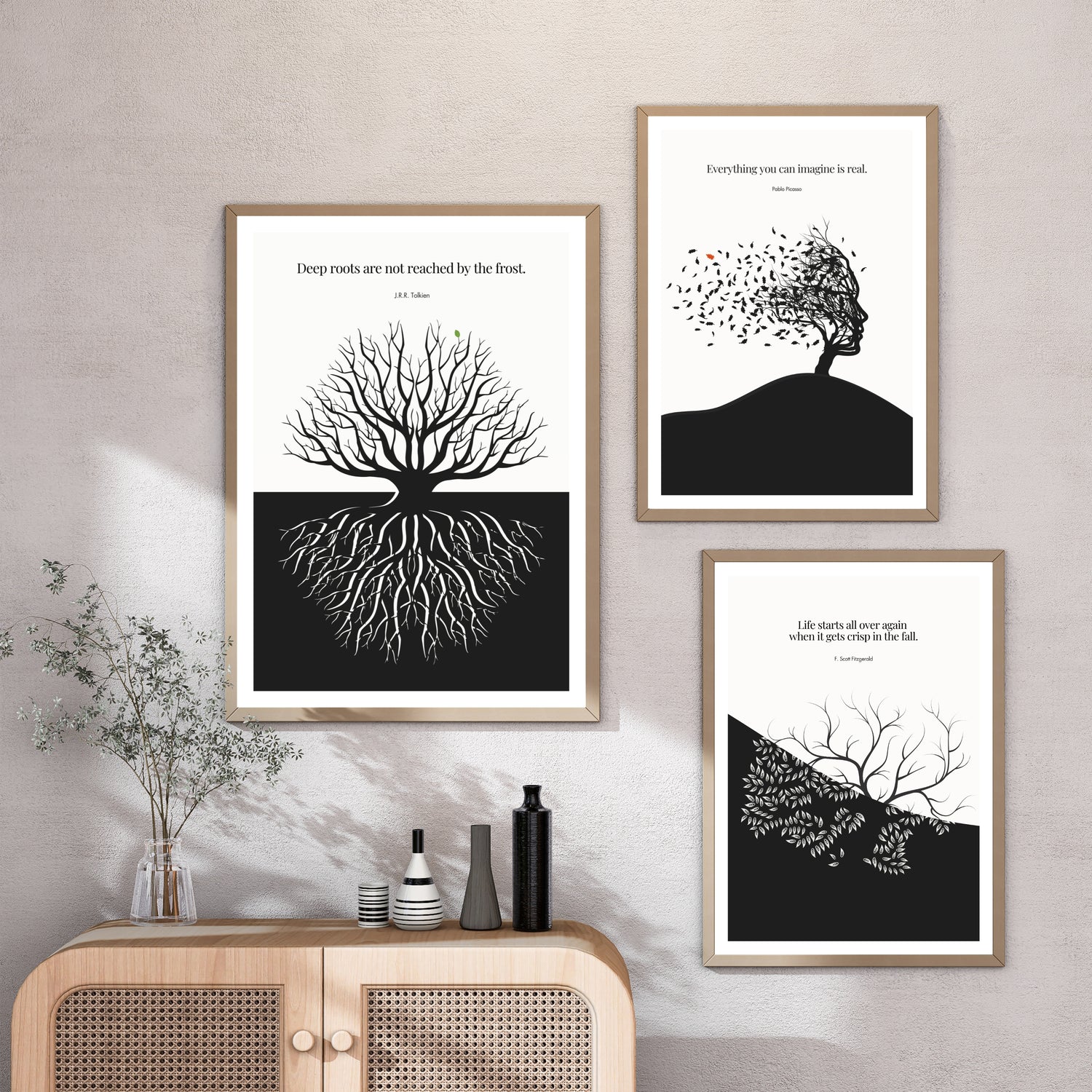 Black and white quote posters in dark frames arranged as a gallery wall in a modern monochrome interior