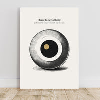 Minimalist poster featuring a large engraved eye sphere with crosshatch detail and golden pupil on cream background — I have to see a thing a thousand times before I see it once quote by Monoquote