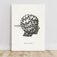 Art print with a head silhouette made of puzzle pieces on a white background