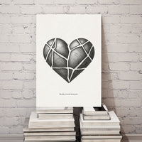 Heart-shaped design on a white canvas against a white brick wall