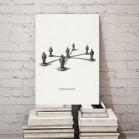 Canvas print with a black and white illustration of interconnected people on a stack of books against a white brick wall.