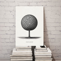 Black and white tree design on a canvas, stacked on books against a white brick wall.