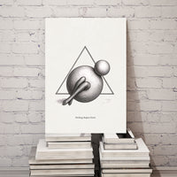 Art print with geometric design on a stack of books against a white brick wall