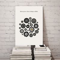 Canvas with gear design and text on a stack of books against a white brick wall.