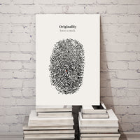 Poster with fingerprint design and text 'Originality leaves a mark' on a stack of books against a white brick wall.