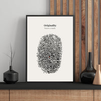 Framed artwork with fingerprint design and text on a wall with decorative vases.