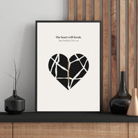 Framed poster with a black heart design and text on a wall with decorative vases.
