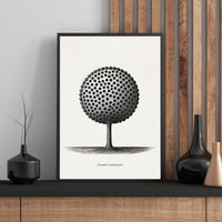 Framed black and white artwork of a tree with a patterned design on a wall.