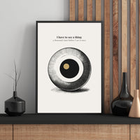 Minimalist poster featuring a large engraved eye sphere with crosshatch detail and golden pupil on cream background — I have to see a thing a thousand times before I see it once quote by Monoquote