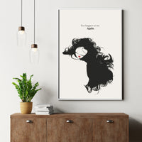 Framed artwork of a stylized woman with text above a wooden cabinet with a plant and books.