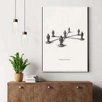 Framed artwork of a network diagram on a wall above a wooden cabinet with a plant and books.