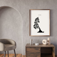 Framed black and white artwork on a wall above a wooden console table with decorative items.