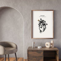 Framed artwork on a wall above a wooden desk with decorative items.