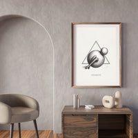 Framed abstract art print on a wall above a wooden side table with decorative items.