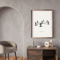 Framed artwork on a wall above a wooden console table with decorative items.