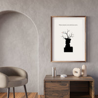 Framed artwork on a wall above a wooden console table with decorative items.