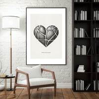 Heart-shaped artwork in a modern living room with a chair, lamp, and bookshelf.