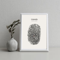 Framed artwork with fingerprint design and text on a gray wall with a vase.