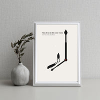 Framed artwork with a clock design and text on a gray wall with a vase.