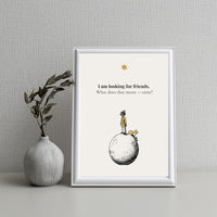 Framed artwork with a quote and illustration of a child on a moon, next to a vase with greenery on a textured wall background.