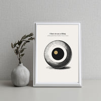 Minimalist poster featuring a large engraved eye sphere with crosshatch detail and golden pupil on cream background — I have to see a thing a thousand times before I see it once quote by Monoquote