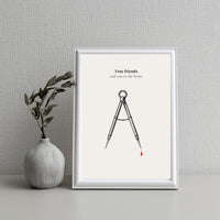 Framed artwork with a compass and text on a white background, next to a vase with leaves.