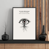 Framed artwork with an eye illustration and text on a wall with decorative elements.