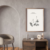 Framed artwork on a wall above a wooden console table with decorative items.