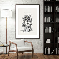 Minimalist black and white poster featuring a hand holding blooming flowers with the quote “Care creates what survives”
