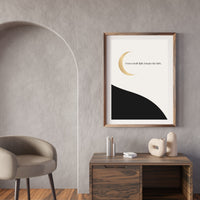 Framed artwork on a wall with a chair and table in a room.