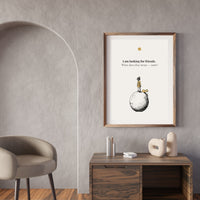 Framed artwork on a wall above a wooden desk with decorative items.