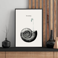 Framed artwork with a black and white illustration of a spiral design on a white background, placed on a wooden shelf.