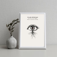 Minimalist poster of a detailed ink-drawn eye with a red heart in the pupil and roots growing from beneath on cream background — It is only with the heart that one can see rightly quote by Monoquote