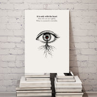 Poster with an eye illustration and text on a stack of books against a white brick wall.
