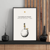 Framed artwork with a quote and illustration of a child on a moon, placed on a wooden shelf.