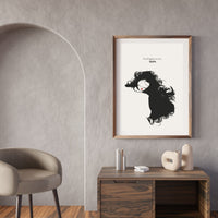 Framed artwork of a woman with flowing hair on a wall above a wooden console table.