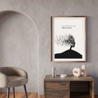 Framed artwork on a wall with a chair and table in the foreground